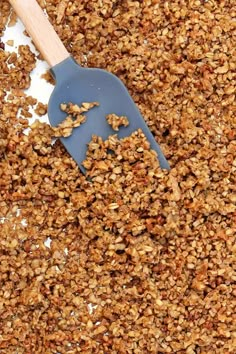 a spatula filled with granola on top of a table