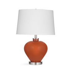 an orange table lamp with a white shade