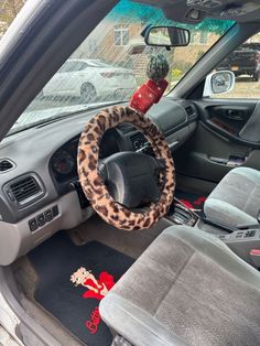 a leopard print steering wheel cover on the dashboard of a car