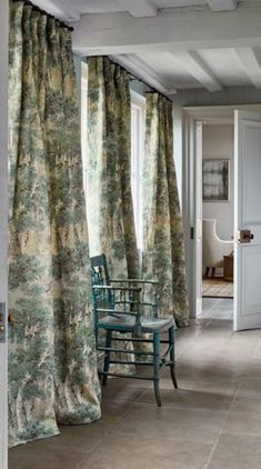 a living room filled with furniture and curtains