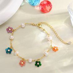 Experience the essence of summer with our Colorful Flowers Pearl Bracelet. Adorn yourself with these playful and elegant shimmering gemstones that exude grace and charm. Each delicate flower is uniquely crafted to add a touch of exquisite glamour Perfect for any outfit in any occasion. Every woman deserves have these lovely pieces. Let the gentle luster of pearls elevate your style! DETAILS Plating: 18K Gold Materials: 18K Gold on Brass, Natural stones, Pearl Measurements: Length: 6.49"(16.5cm)+ Diy Pearl Hair Accessories, Wrist Stacks, Pearl Jewels, Hair Accessories Pearl, Pearls Diy, Beads Bracelet Design, Charms Bracelet, Natural Stone Jewelry, Bead Charm Bracelet