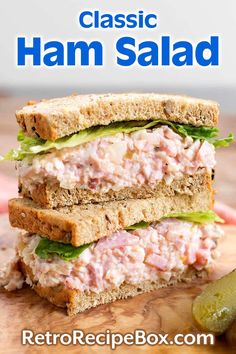 a close up of a sandwich on a cutting board with the words classic ham salad