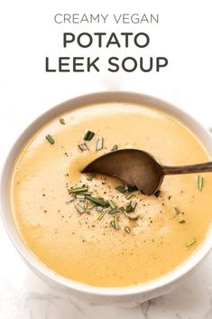 creamy vegan potato leek soup in a white bowl with a spoon