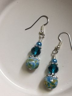 These beaded dangle earrings will look great hanging from your ears at work, on a night out, or a day of shopping. The beautiful glass multi colored beads make this pair of earrings irresistible. Earrings are made using surgical steel ear wires. I use wrapped loops to give a finished look. Earrings come with rubber ear backs that slide on to keep earrings from falling out of ears.Color: aqua blue, olive green, pale blueEarrings length: see pictureORDERS PROCESS AND SHIP IN 1-5 BUSINESS DAYS. Lar Cheap Green Earrings With French Hook, Glass Drop Earrings With Lever Back Ear Wires, Blue Czech Glass Beaded Earrings For Pierced Ears, Blue Glass Beaded Earrings With Ear Wire, Blue Adjustable Czech Glass Beaded Earrings, Green Sea Glass Earrings With Ear Wire, Bead Knit, Beaded Earrings Diy, Electronic Gifts