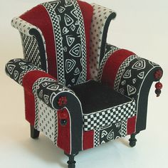 a red and black chair sitting on top of a white table