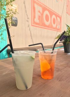 two drinks sitting on top of a wooden table