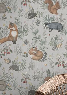 a basket sitting on top of a table next to a wallpaper covered in animals