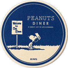 a blue and white plate with a cartoon character holding a sign that says peanuts diner