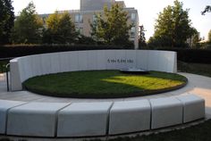 a circular bench in the middle of a grassy area