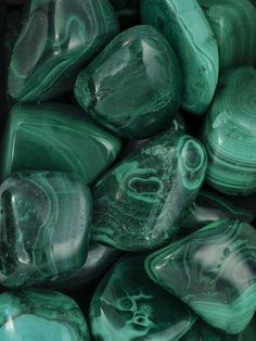 green marbles are stacked together in a pile