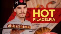 a man holding a plate with food on it and the words hot fiadelfa in front of him