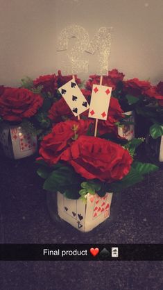 roses and cards are arranged in a vase with the word i love you on it