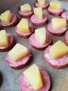 small pastries with cheese and ham are on a baking sheet, ready to be baked