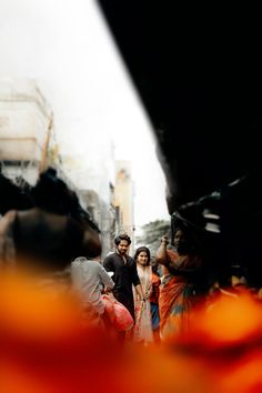 a group of people walking down a street next to each other