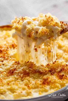 a spoonful of macaroni and cheese being lifted from a casserole dish