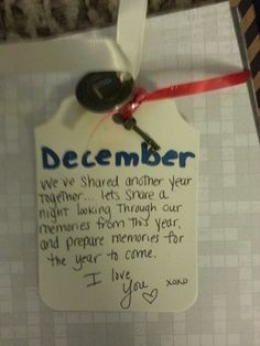 a note attached to a door with a key hanging from it's side and the words december written on it