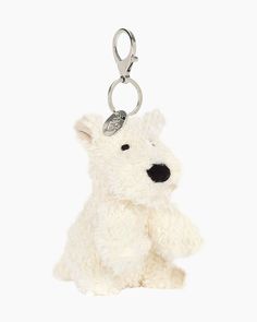 a white teddy bear keychain with a black nose