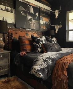 a bed room with a neatly made bed and cow heads on the wall above it