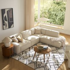 a living room with a large sectional couch and coffee table in the middle of it