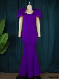 a mannequin wearing a purple dress with ruffles on the shoulders and neckline