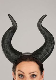 a woman with black horns on her head