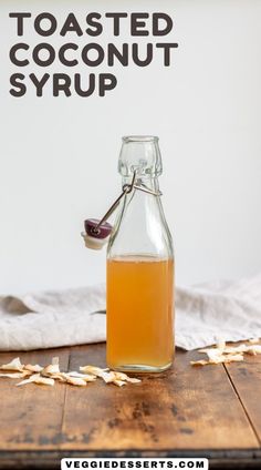 a bottle filled with liquid sitting on top of a wooden table