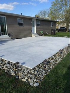 a house that has some rocks in front of it