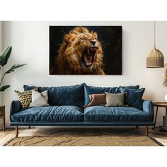 a living room with a blue couch and an animal painting on the wall above it