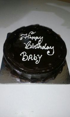 a birthday cake with the words happy birthday baby on it's black frosting