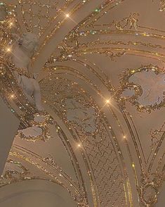 the ceiling is decorated with gold glitters and angel statues on it's sides