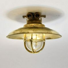 an old fashioned brass light fixture with two bulbs on the side and one bulb in the middle