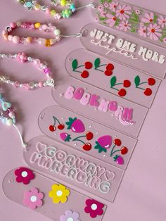 the name tags are decorated with flowers, beads and other things to make it look like they have been made out of plastic