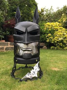 a helmet made out of metal with ears and horns on the head, sitting in grass