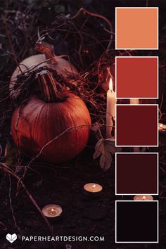 a pumpkin sitting on the ground next to candles