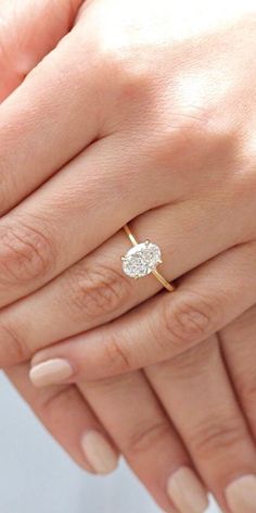 a woman's hand with a diamond ring on it