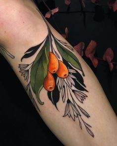 an orange tree branch with leaves and berries on it's arm, done by @ berlin, germany