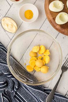 the ingredients for deviled eggs in a glass bowl