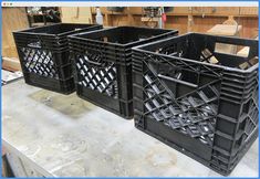 two black plastic crates sitting on top of a table