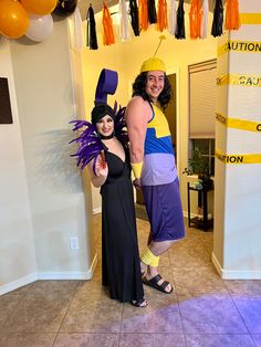 two people dressed up in costumes standing next to each other