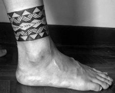 a close up of a person's foot with a tattoo on the side of it