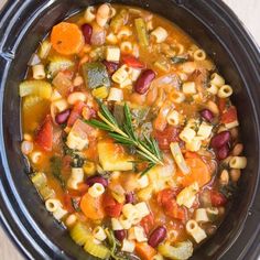 a crock pot filled with pasta and vegetables