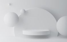 an abstract white background with three balls and two circles on the wall, in front of a circular shelf