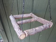 a tree swing made out of branches and chains