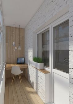 a computer desk sitting next to a window on top of a hard wood floor in front of a white brick wall