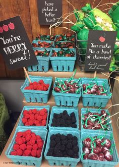 there are many different types of berries on display at the market table with signs that say you're berry sweet