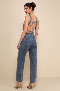 Everyone will wanna copy your perfect style in a look like the Lulus Trendsetting Personality Medium Wash Denim Backless Jumpsuit! Sturdy, woven cotton denim shapes this iconic jumpsuit that has wide straps and a seamed bodice with a sweetheart neckline. Slender straps tie across the stunning open back, creating an ultra-summery effect. Figure-flaunting waist tops wide legs with paneled seaming that finish at ankle-length hems. Hidden zipper/clasp at back. Fit: This garment fits true to size. Le Trendy Jumpsuits For Women, Jumpsuit Denim, Trendy Jumpsuit, Backless Jumpsuit, Jean Overalls, Wide Legs, Denim Jumpsuit, Woven Cotton, Jumpsuits For Women