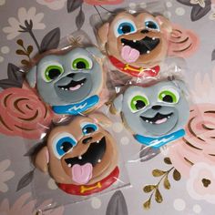 four decorated cookies in the shape of dogs