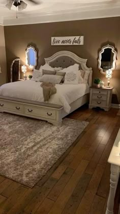 a bedroom with a bed, dressers and mirror on the wall next to it