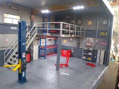 the inside of a garage with ladders and shelves