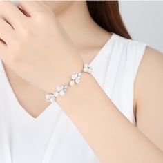 Gorgeous natural real pearl floral leaf diamond crystal wedding bridal bridesmaids bracelet, super sparkly and stunning. Handmade of top quality natural ivory pearls, AAA diamond CZ, and 925 sterling silver. 17cm length, 1.5 cm width, with exquisite buckle closure. Delicate elegant bracelet looks perfect as wedding bridal bridesmaid jewelry, or just as everyday high end accessories. Beautiful shimmery last for years, best quality guaranteed. 💎 Features: ♥ Material: Real gold plated 925 sterling silver ♥ Main stone: Top quality natural freshwater ivory pearls ♥ Side Stone: Cz crystal 💎 Details: ♥ Approximate Measurements: - Length: 17 cm - Width: 1.5 cm ♥ Lightweight, easy to wear ♥ Nickel/Lead Free, Hypoallergenic, good for sensitive skins 🎁 Packing & Shipping: ♥ All our jewelry will be Elegant Cubic Zirconia Beaded Bracelets, Elegant Flower Bracelets For Formal Occasions, Adjustable Flower-shaped Pearl Jewelry, Elegant Bracelet With Sparkling Stones, White Pearl Jewelry With Sparkling Stones, Elegant Crystal Jewelry With Pearl Chain, Delicate Formal Pearl Bracelet, Elegant Silver Crystal Bracelet With Pearl Charm, Delicate Pearl Bracelet Jewelry